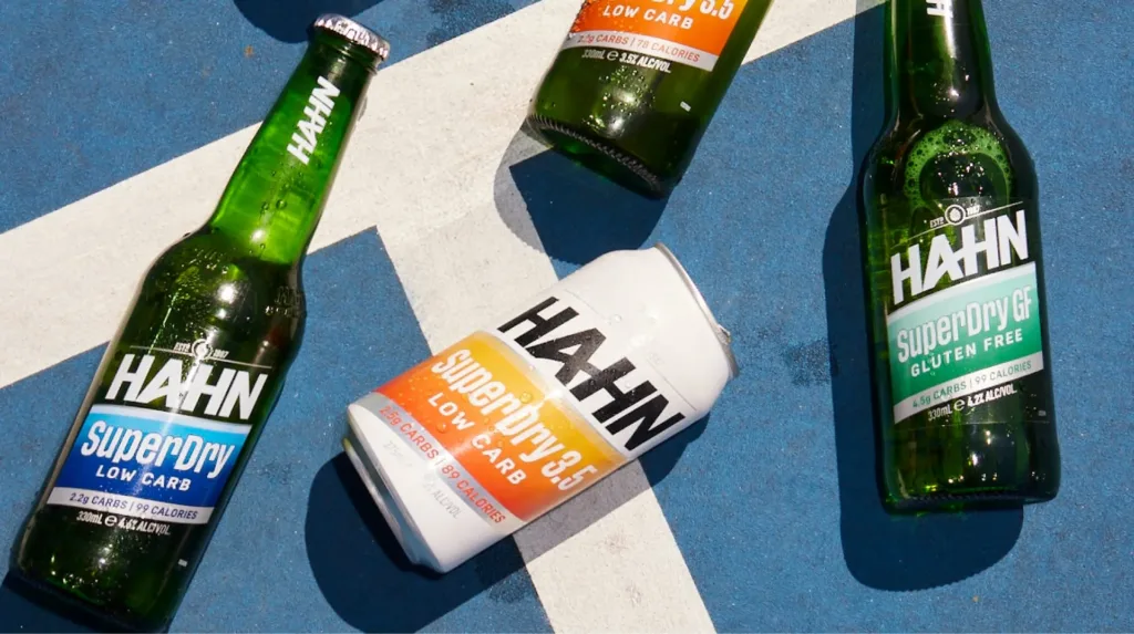 Flat-lay photo of Hahn beers resting on a blue sports court